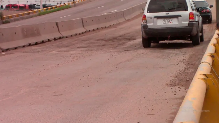 Provocan accidentes baches del distribuidor vial del Greco